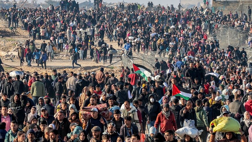 People walk northwards along a coastal in Gaza after Israel opened the way following a deal on future hostage exchanges