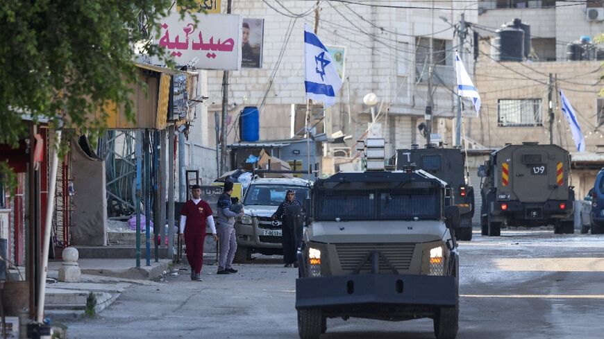 Israeli forces in armoured vehicles conduct a raid in Jenin in the occupied West Bank