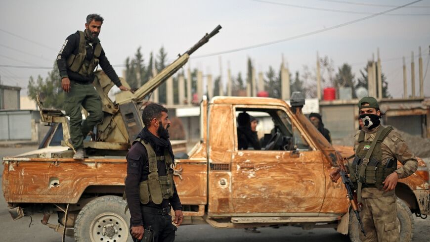 Fighters affiliated with the Turkish-backed Syrian National Army faction patrol in the Manbij region of Syria's Aleppo province on January 4, 2025