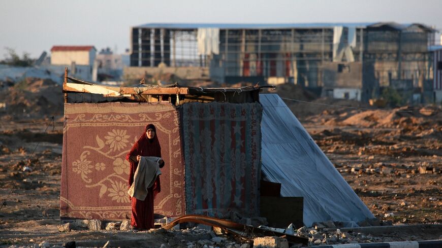 A displaced Palestinian at sunrise in Bureij, central Gaza, shortly before the ceasefire was to be implemented