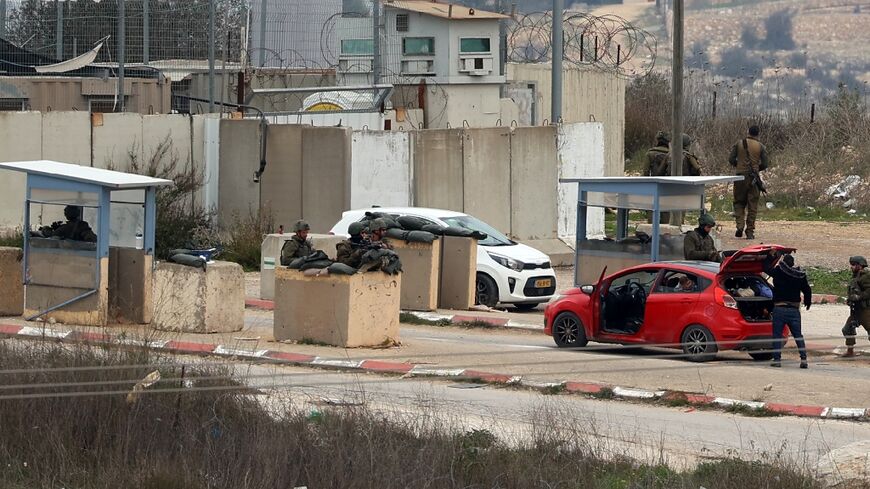 Palestinians sometimes wait hours on their way home from work while cars are searched and IDs verified