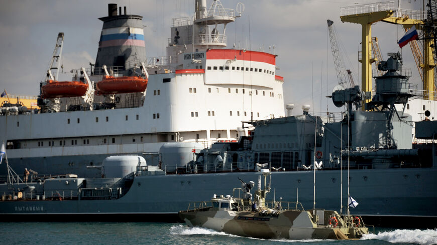 A Russian ship is pictured in front of fleet replenishment oiler Ivan Bubnov (L) at the Russian naval base in the port of Tartus, Syria, Sept. 26, 2019.