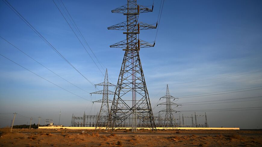 Power pylons stand next to a substation transmitting electricity from Uzbekistan to Afghanistan along the Hairatan Highway, Kaldar district, Balkh Province, Afghanistan, Oct. 27, 2021.