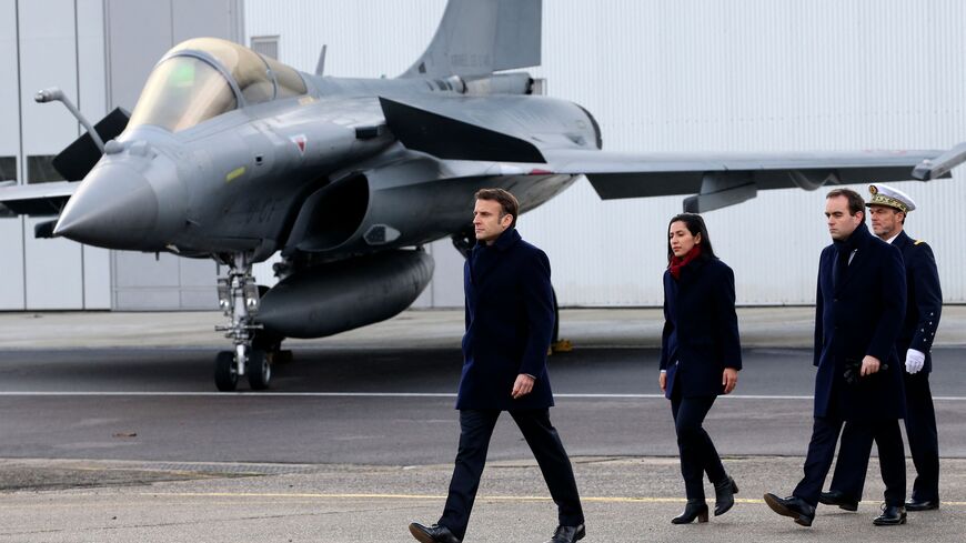 French President Emmanuel Macron, followed by French Armies Minister Sebastien Lecornu (2nd R), walks past a Dassault Rafale fighter aircraft during his New Year address to the French Army at the Mont-de-Marsan air base, southwestern France, on January 20, 2023. (Photo by Bob Edme / POOL / AFP) (Photo by BOB EDME/POOL/AFP via Getty Images)