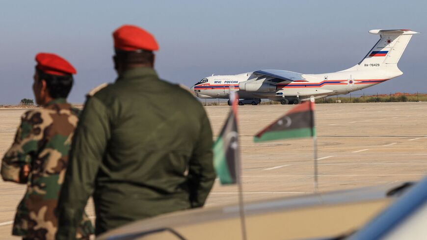 Military personnel supervise the arrival of aid carried by an Ilyushin Il-76TD transport aircraft of the Russian Ministry for Emergency Situations, for survivors of the floods that submerged Libya's eastern city of Derna at the airport of Benghazi on September 16, 2023. The floods washed thousands of people and homes out to sea after two upstream dams burst under the pressure of torrential rains triggered by the hurricane-strength storm "Daniel". (Photo by Karim SAHIB / AFP) (Photo by KARIM SAHIB/AFP via Ge