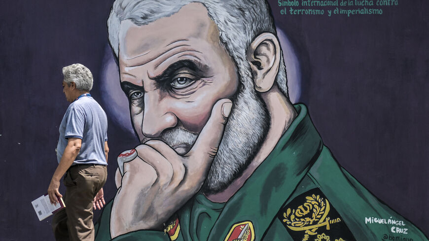 A man walks past a mural depicting slain commander of the IRGC's Quds Force Qasem Soleimani in Caracas on April 26, 2024. (Photo by Juan BARRETO / AFP) (Photo by JUAN BARRETO/AFP via Getty Images)