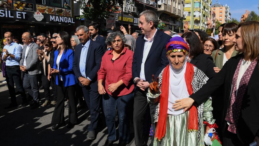 DEM Party co-chair Tuncer Bakirhan (C) walks with party members and attendees during a rally organized by the pro-Kurdish Equality and Democracy (DEM) Party