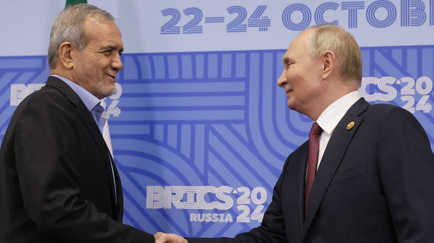 Russian President Vladimir Putin meets with Iranian President Masoud Pezeshkian on the sidelines of the BRICS summit in Kazan on Oct. 23, 2024.