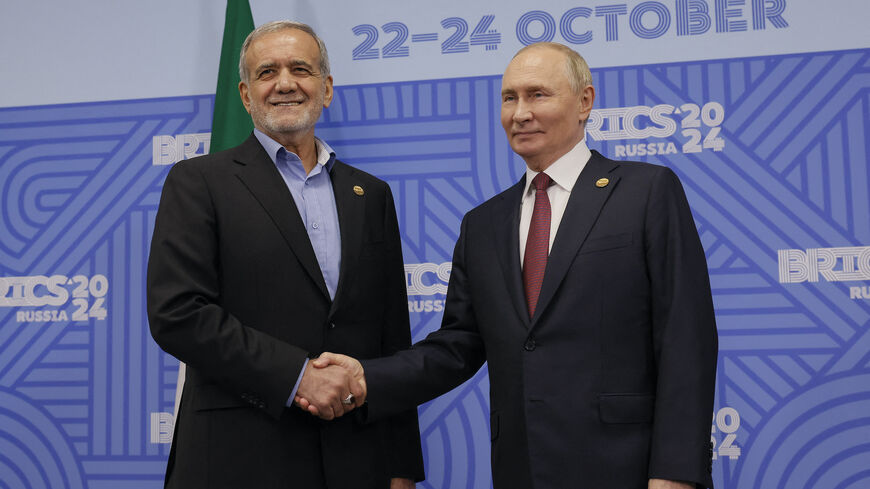 Russian President Vladimir Putin meets with Iranian President Masoud Pezeshkian on the sidelines of the BRICS summit in Kazan on Oct. 23, 2024. 