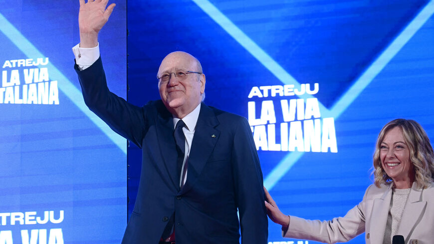 TOPSHOT - Lebanon's caretaker Prime Minister Najib Mikati waves from the stage next to Italy's Prime Minister Giorgia Meloni during the Atreju political meeting organised by the young militants of Italian right wing party Brothers of Italy (Fratelli d'Italia) on December 14, 2024 in Rome. (Photo by Filippo MONTEFORTE / AFP) (Photo by FILIPPO MONTEFORTE/AFP via Getty Images)