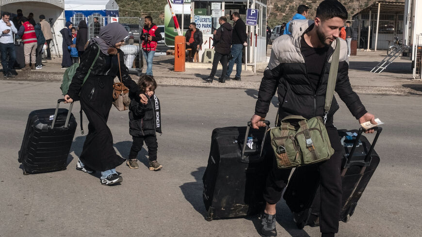 Syrians living in Turkey carry their belongings towards the Cilvegozu border gate to cross into Syria after after Syrian rebels ousted President Bashar al-Assad on Dec. 13, 2024 in Cilvegozu, Turkey. 