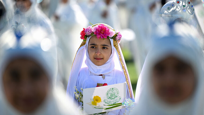 Iraqi Muslim girls, who traditionally begin wearing the hijaba head covering worn in publicat the mandatory age of nine, take part in a ceremony organized at a stadium in Basra on December 19, 2024. (Photo by Hussein FALEH / AFP) (Photo by HUSSEIN FALEH/AFP via Getty Images)