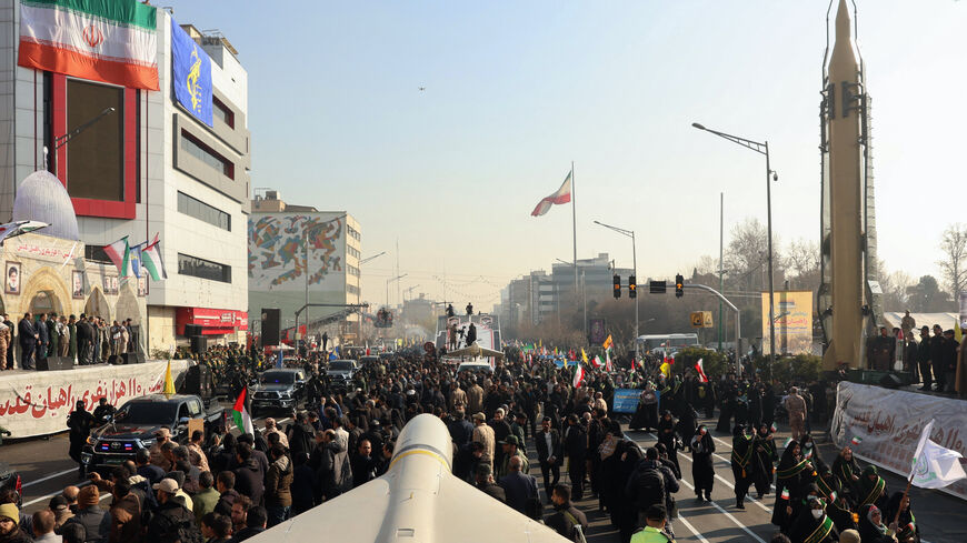 Members of Iranian paramilitary forces (Basij) march next to a Iranian long range Sejil missile, during an anti-Israeli rally to show their solidarity with the Palestinian and Lebanese people, in Tehran, Jan. 10, 2025. 