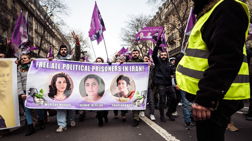 People carry a banner during a march demanding truth and justice for Kurdish activists, Paris, Jan. 11, 2025.