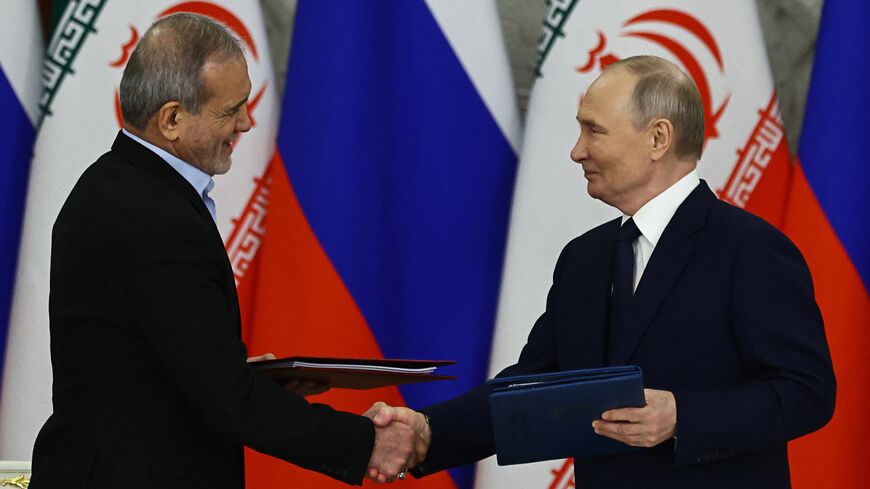 Russian President Vladimir Putin and Iranian President Masoud Pezeshkian sign a strategic partnership treaty during a ceremony following their talks at the Kremlin in Moscow on Jan. 17, 2025. 