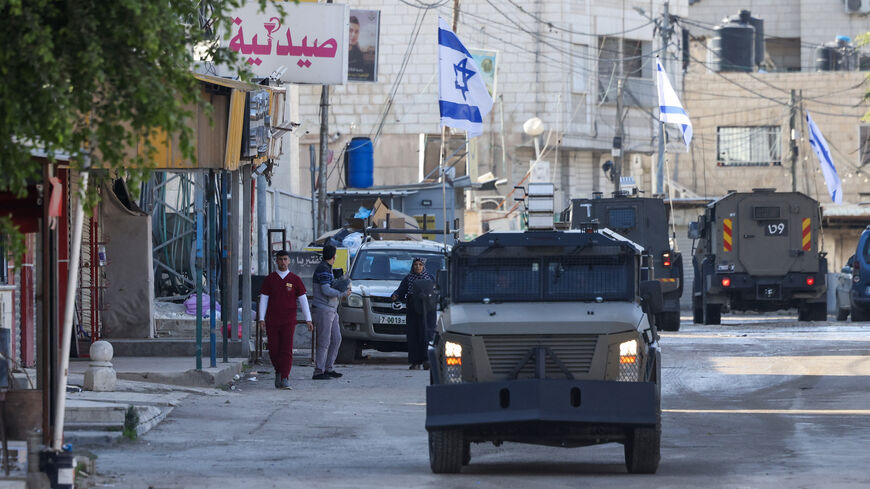 Israeli forces in armored vehicles conduct a raid in Jenin in the occupied West Bank on Jan. 21, 2025. 