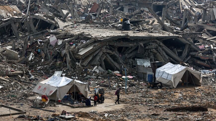 People in Jabalia erect tents amid the rubble of destroyed buildings as displaced Palestinians return to northern Gaza during a ceasefire in the war between Israel and Hamas, Jan. 23, 2025. 