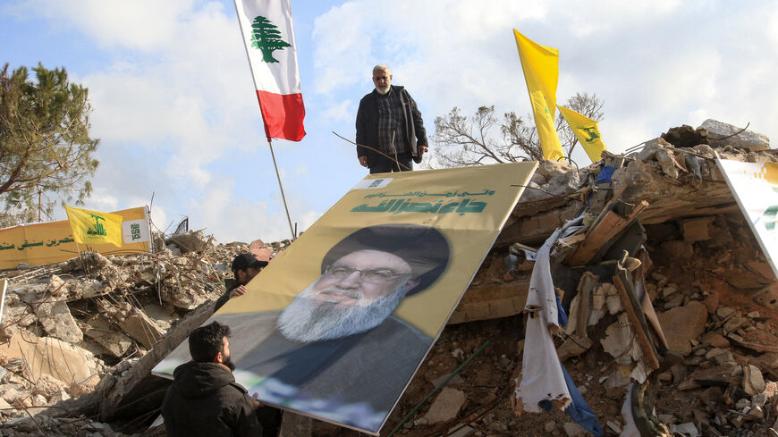 People place a picture of slain Hezbollah leader Hassan Nasrallah over the rubble of the shrine of Shamoun al-Safa, built within a castle in the village of Shamaa in southern Lebanon's Tyre governorate on January 31, 2025, that was heavily damaged by Israeli bombing. The hilltop castle houses the Muslim Shiite pilgrimage site over a tomb said by some to be that of Simon the Zealot, one of the 12 apostles of Jesus Christ, and by others of Simon, second son of the Biblical patriarch Jacob. (Photo by Mahmoud Z