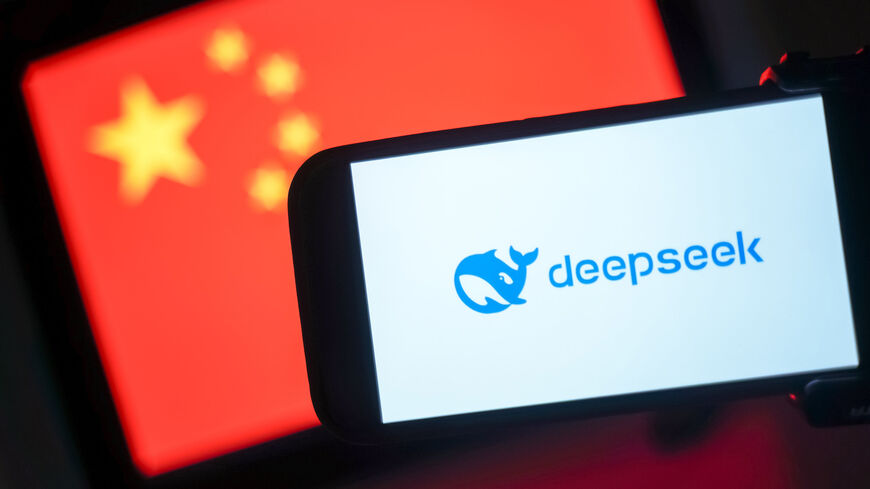 In this photo illustration, the DeepSeek logo is seen on a phone in front of a flag of China, Hong Kong, Jan. 28, 2025.