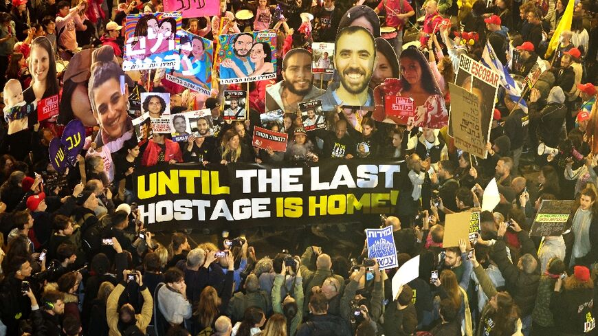 People gathered in Tel Aviv hold placards during an anti-government protest calling for action to secure the release of Israeli hostages held in Gaza