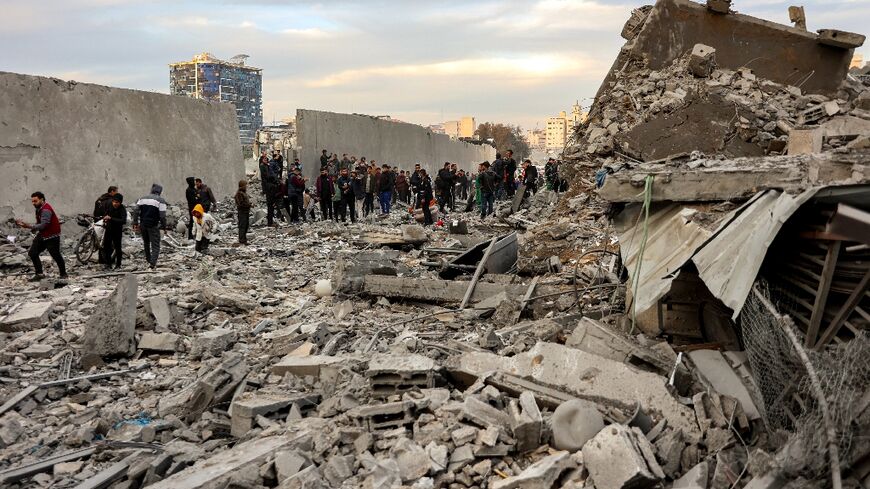 People inspect the aftermath of an Israeli strike in central Gaza over the weekend