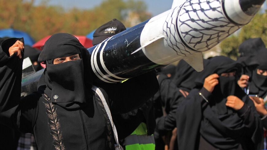 A Yemeni protester holds a mock rocket during an anti-Israel demonstration in the Huthi-controlled capital of Sanaa on January 22, 2025