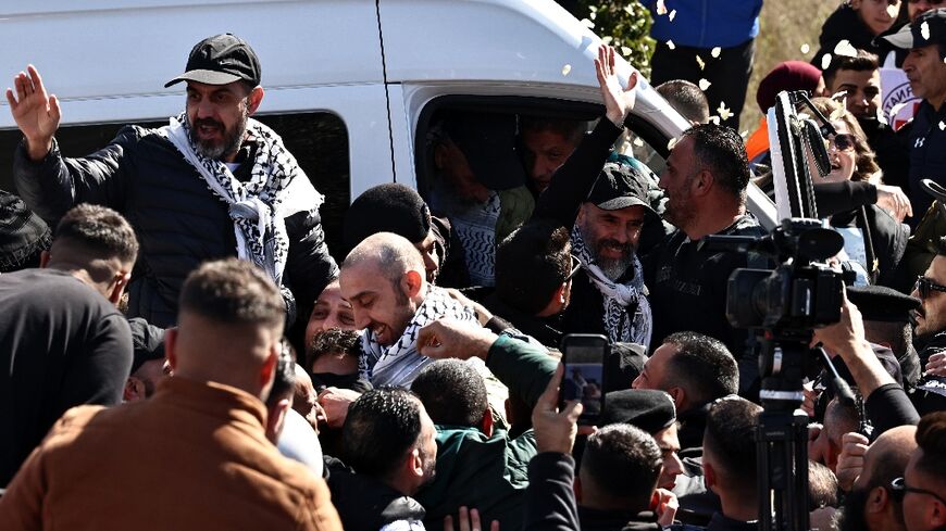 A cheering crowd hoisted freed Palestinian prisoners onto their shoulders after they arrived in the occupied West Bank city of Ramallah