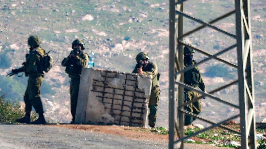 Israeli soldiers guard the scene of a shooting at the Tayasir checkpoint east of Tubas in the northern West Bank