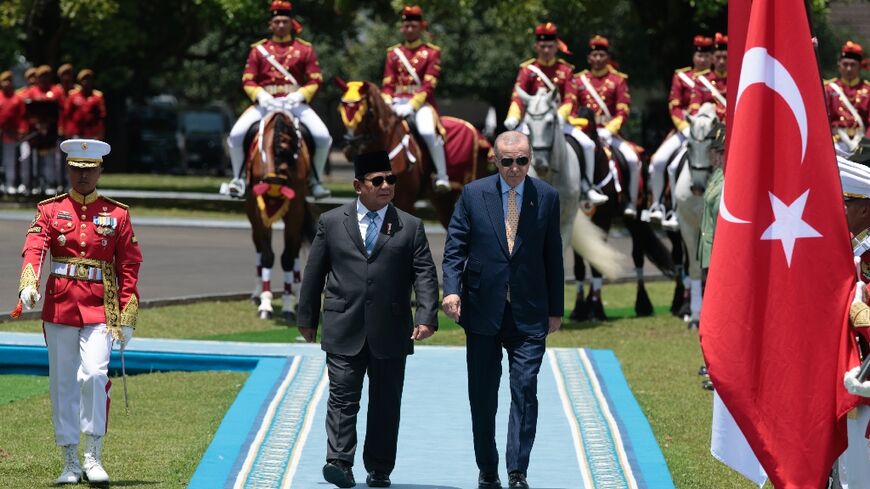 Indonesia's President Prabowo Subianto and Turkey's President Recep Tayyip Erdogan inspect a guard of honour