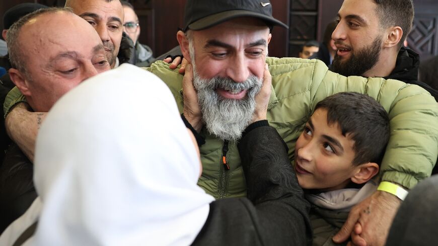 Relatives in the occupied West Bank city of Ramallah greet a Palestinian prisoner released as part of the sixth hostage-prisoner exchange under a Gaza truce deal