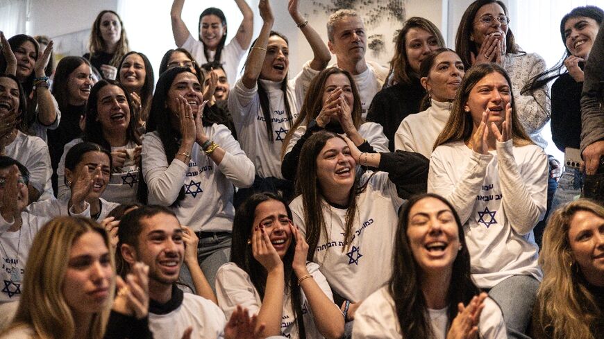 Friends and family of Israeli hostage Omer Shem Tov celebrate as they watch his televised release by Hamas militants at his family home in Tel Aviv