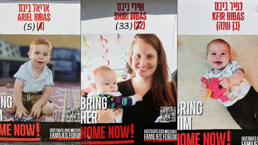 Posters show Israeli hostages Shiri Bibas (C) and her two children Ariel (L) and Kfir (R) -- militants handed over their bodies to the Red Cross, along with that of a fourth Israeli