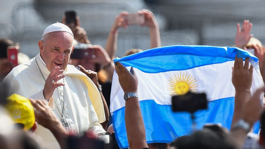 A worshiper waves the flag of Argentina as Pope Francis arrives for the weekly general audience on June 5, 2019 at St. Peter's square in the Vatican. (Photo by Vincenzo PINTO / AFP) (Photo credit should read VINCENZO PINTO/AFP via Getty Images)