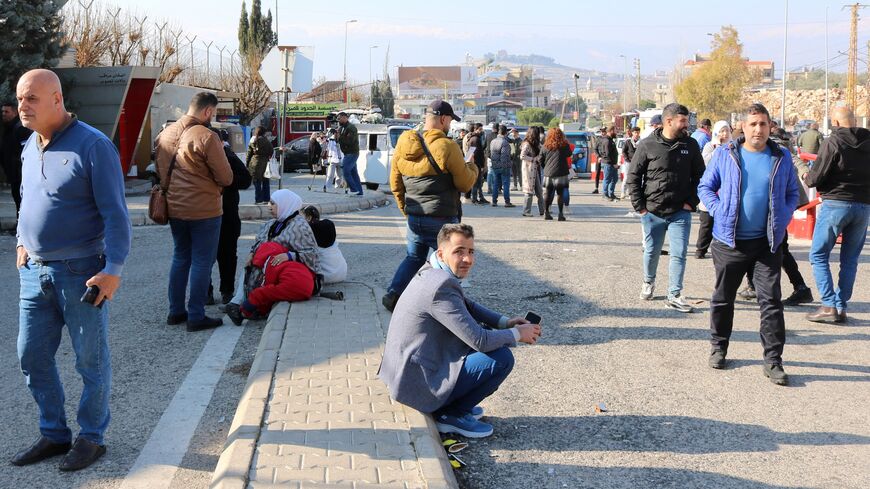 People wait at the entrance of the Al Masnaa eastern Lebanese border crossing with Syria on Jan. 3, 2025, after Syria imposed new restrictions on the entry of Lebanese citizens. 