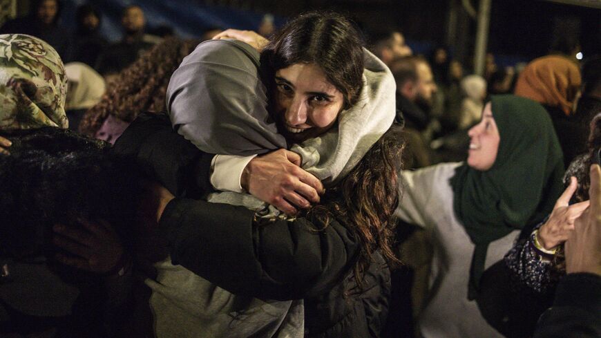 A Palestinian prisoner embraces a relative upon the arrival of some 90 prisoners set free by Israel in the early hours of Jan. 20, 2025, in the occupied West Bank town of Beitunia. 