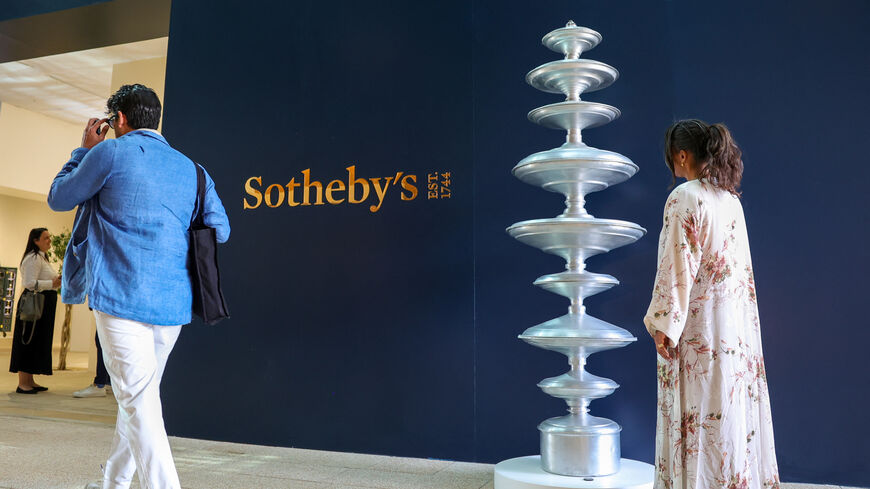 A visitor walks past an installation from the Food for Thought collection by contemporary Saudi artist Maha Malluh on display at Sotheby's Origins exhibition ahead of its international auction in Diriyah in Riyadh on February 5, 2025. (Photo by Fayez Nureldine / AFP) / RESTRICTED TO EDITORIAL USE - MANDATORY MENTION OF THE ARTIST UPON PUBLICATION - TO ILLUSTRATE THE EVENT AS SPECIFIED IN THE CAPTION (Photo by FAYEZ NURELDINE/AFP via Getty Images)