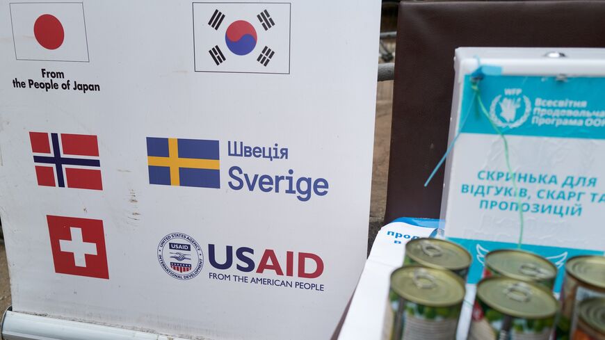 A banner lists the countries funding the World Food Program at a food distribution point run by the Ukrainian charity Angels of Salvation (AOS), on Feb. 7, 2025, in Druzhkivka, Ukraine.