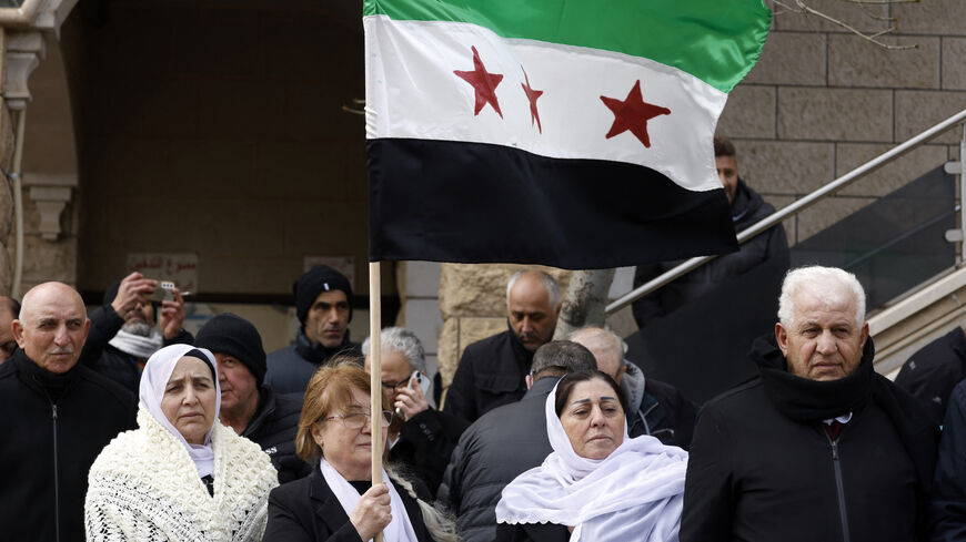 Druze residents of the village of Majdal Shams in the Israeli-annexed Golan Heights wave a Syrian flag as they take part in a rally on Feb. 14, 2025, to protest against the 1981 annexation law of the strategic plateau which Israel captured from Syria during the 1967 Arab-Israeli war.