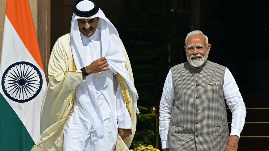 Qatar's Emir Sheikh Tamim bin Hamad Al-Thani (L) walks with India's Prime Minister Narendra Modi before their meeting at the Hyderabad House in New Delhi on Feb. 18, 2025. 