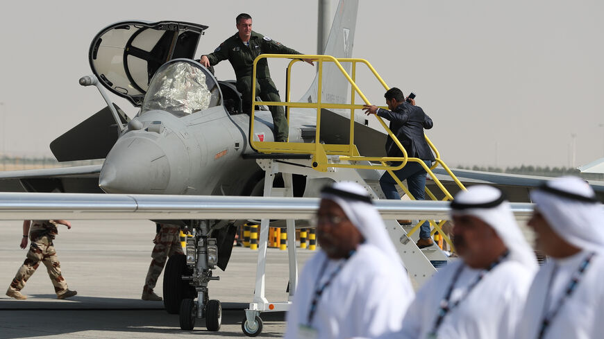 Emiratis walk past a French Rafale fighter jet displayed during the Dubai Airshow on November 14, 2017, in the United Arab Emirates. / AFP PHOTO / KARIM SAHIB (Photo credit should read KARIM SAHIB/AFP via Getty Images)