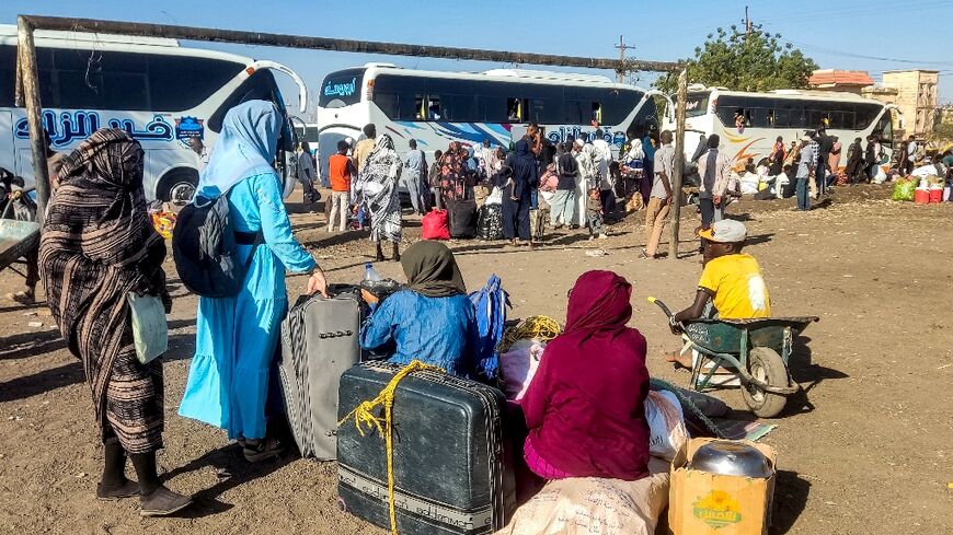 People displaced by the war in Sudan prepare to board buses home to Wad Madani in Jazira state after it was retaken by the army from the RSF