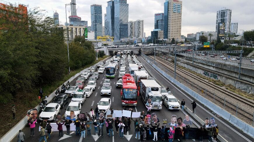 Protesters block a highway in Tel Aviv to demand the release of all hostages held in Gaza after recent develpments threw a truce deal into doubt