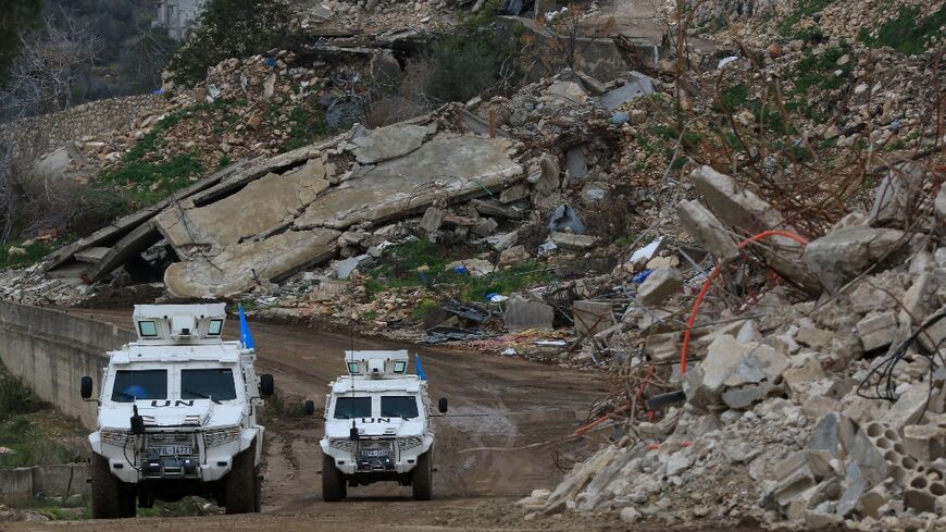 United Nations peacekeepers drive past the rubble of buildings in the southern Lebanese village of Yarine during the ceasefire between Israel and Hezbollah