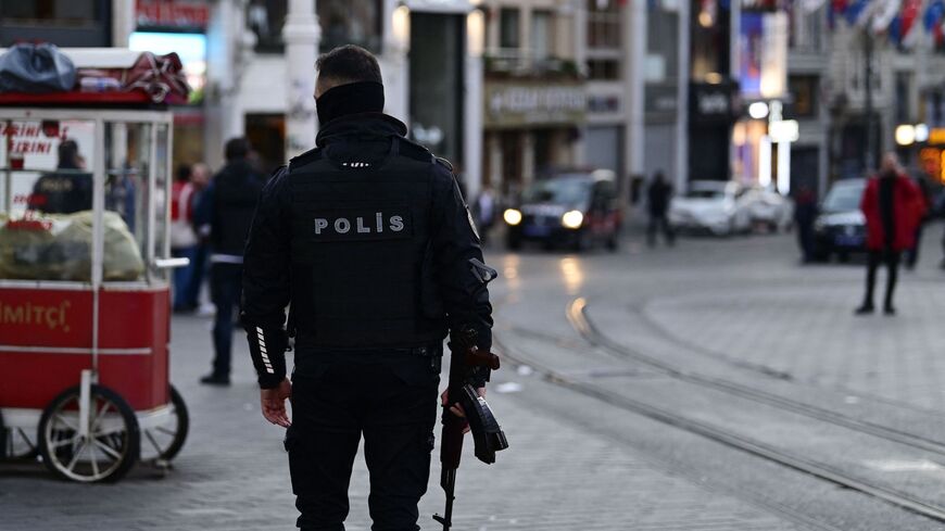 Turkish policemen try to secure the area after a strong explosion of unknown origin shook the busy shopping street of Istiklal in Istanbul, on Nov. 13, 2022. 