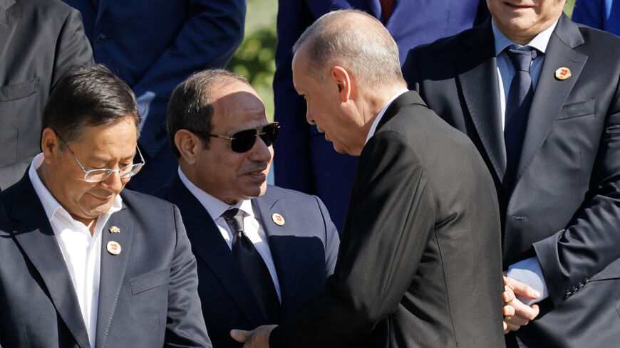 Turkey's President Recep Tayyip Erdoan (3-R) greets Egypt's President Abdel Fattah el-Sisi (2-L) next to Bolivia's President Luis Arce (L) and Argentina's President Javier Milei (R) before the group photo at the end of the first session of the G20 Leaders' Meeting in Rio de Janeiro, Brazil, on November 18, 2024. (Photo by Ludovic MARIN / AFP) (Photo by LUDOVIC MARIN/AFP via Getty Images)