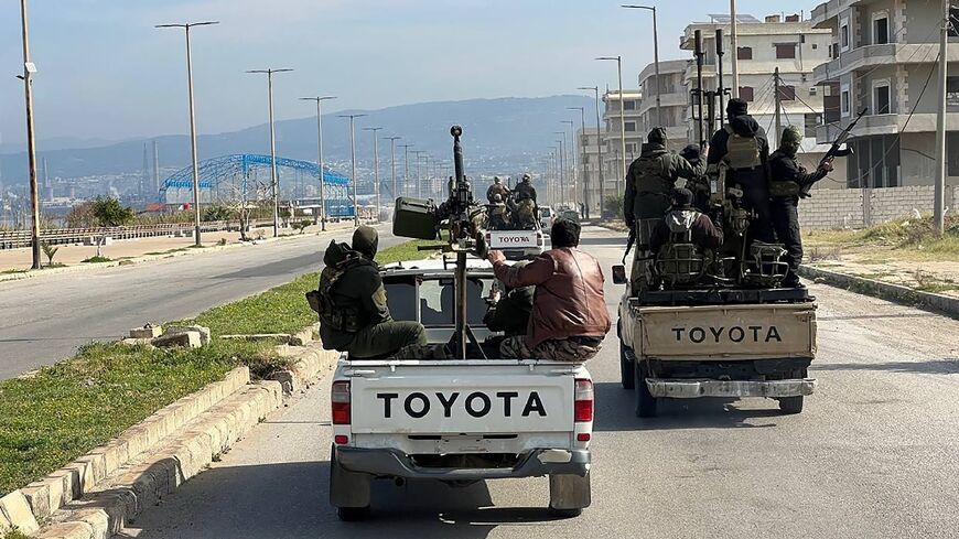 A handout picture from the Syrian state news agency SANA showing members of the security forces in Syria's coastal region