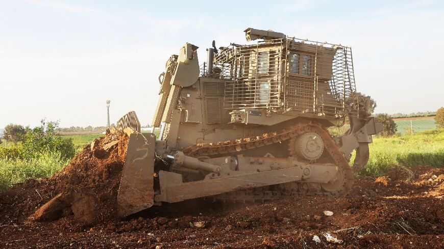 An unmanned D9 bulldozer digs up a field during a demonstration to the press at the Israel Aerospace Industries headquarters