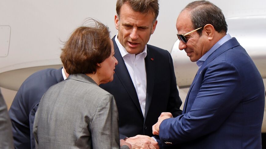 Egypt's President Abdel Fattah al-Sisi (R) and French President Emmanuel Macron (C) arriving in El-Arish 