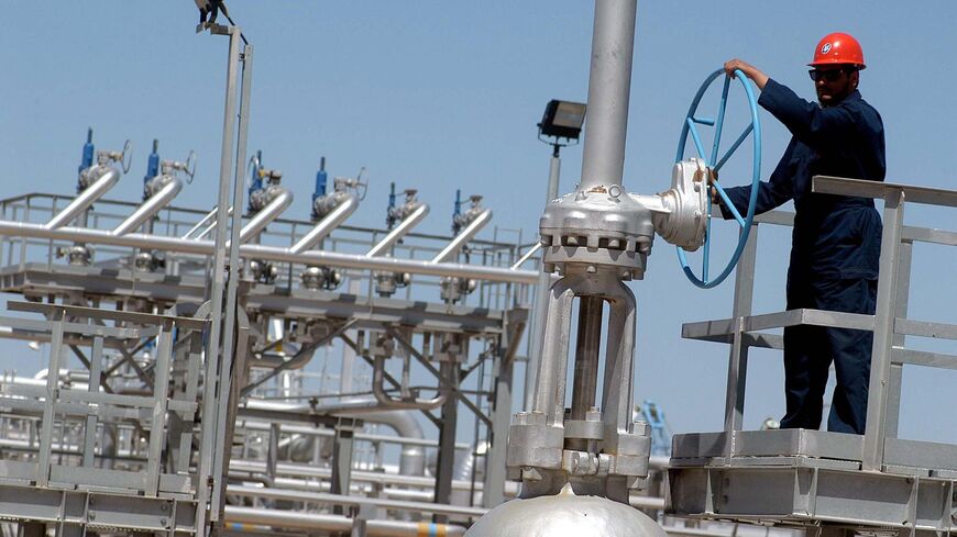 A worker is seen at the Gathering Center 15 (GC 15) oil facility 28 March 2005 in the northern Al-Rawdhatain oilfield, 80 Kms from Kuwait City.