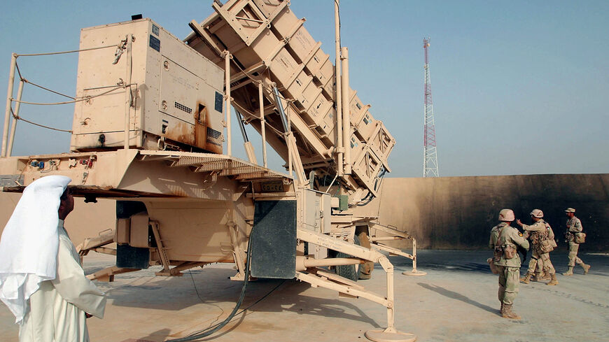 A Kuwaiti reporter gets a close up look at a Patriot missile launcher March 23, 2003, manned by the Kuwait army during a tour in the desert north of Kuwait City.